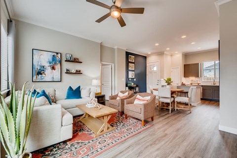 a living room with furniture and a ceiling fan